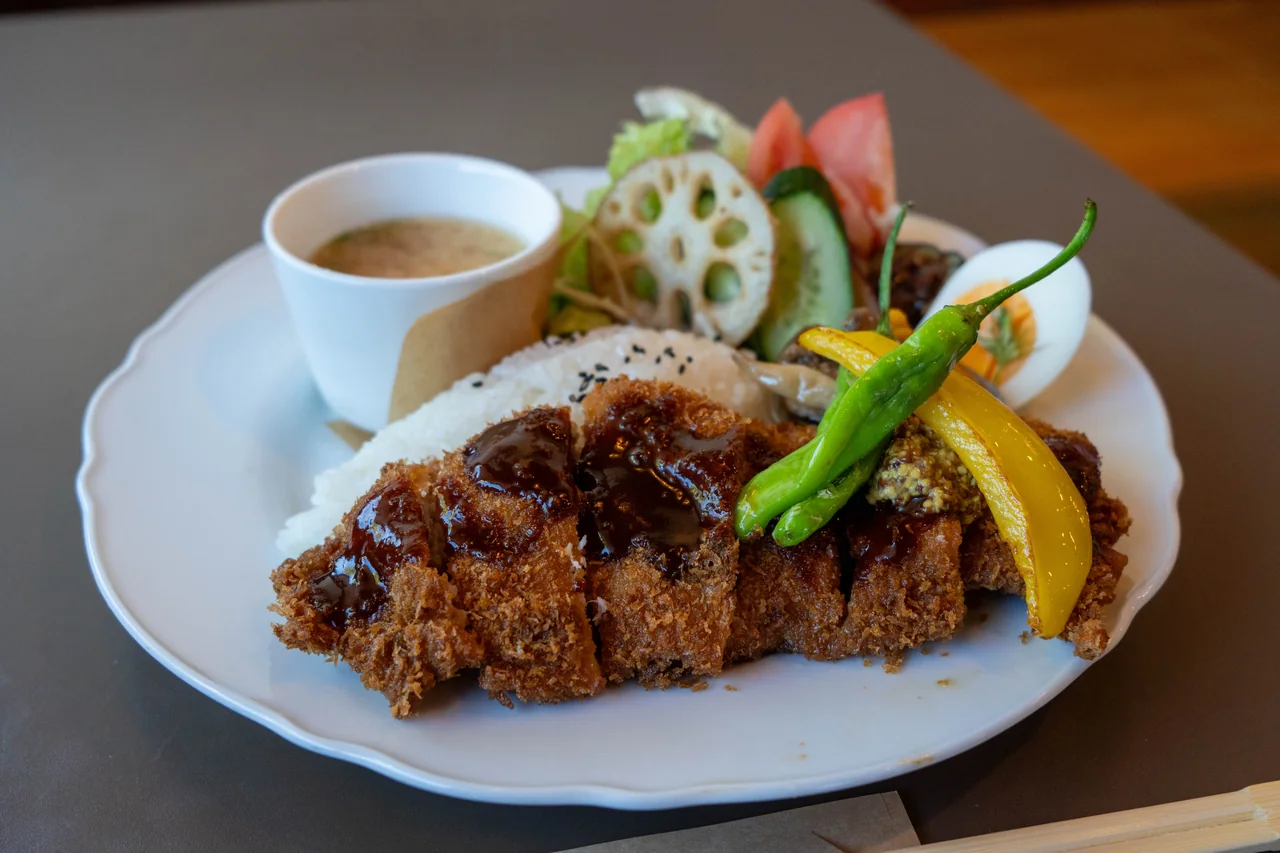 Pork cutlet with colourful vegetables, rice and soup