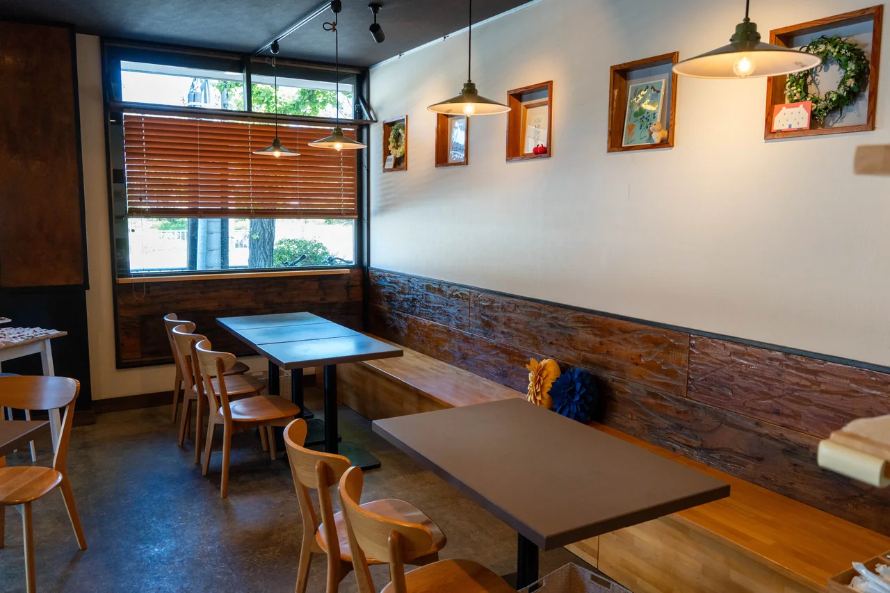 Wooden tables and pendant lights inside the restaurant